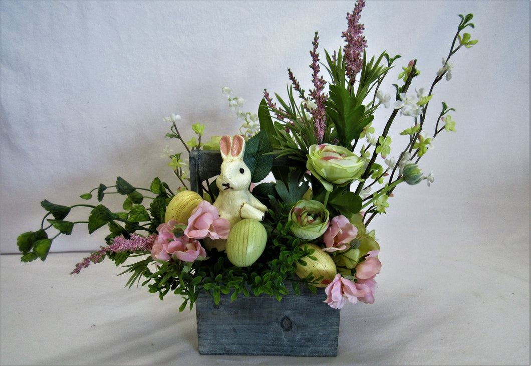 Floral Easter Arrangement in Wooden Basket with Lt. Green, Pink and Purple Florals, Greenery,  Bunny, Speckled Eggs - April's Garden Wreath